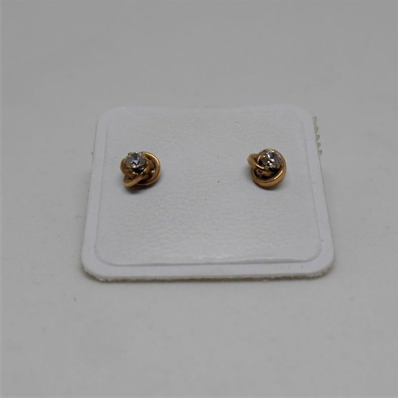 alt=\"pendientes niña de oro de ley 18 K. con circonitas en forma de nudo\"