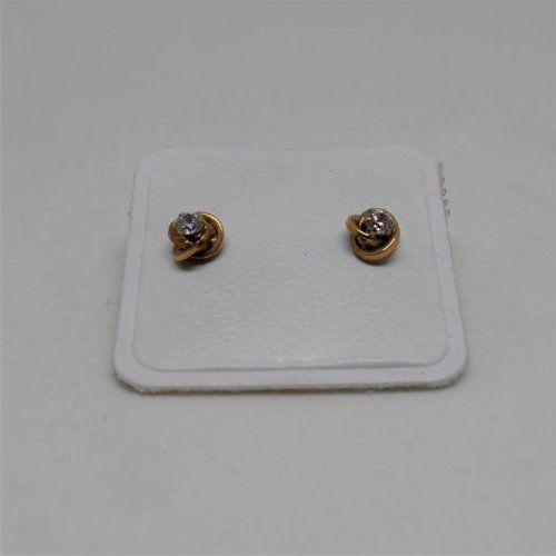alt=\"pendientes niña de oro de ley 18 K. con circonitas en forma de nudo\"