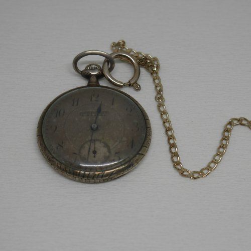 alt=\"Reloj antigüo de bolsillo caballero con cadena y caja de plata de ley marca Gentileza en estado de marcha\"